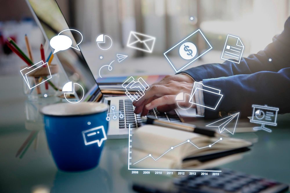 An executive types on his laptop while working in his office