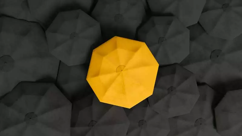 An abstract image of a yellow umbrella in the midst of a lot of black coloured umbrellas