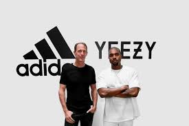 A picture of Adidas CEO and Kanye West standing in front of an Adidas logo 