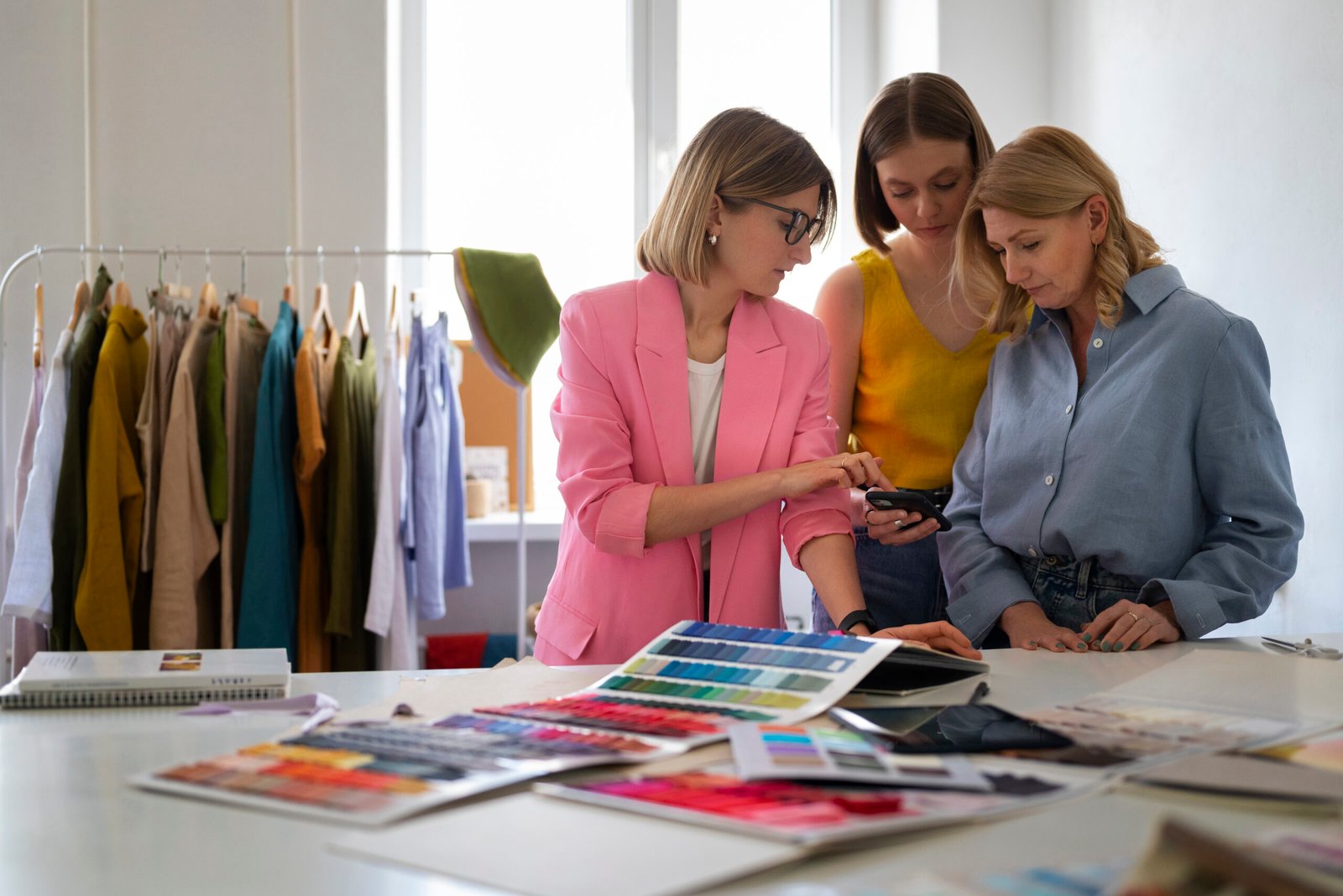 women standing and discussing something while testing colors