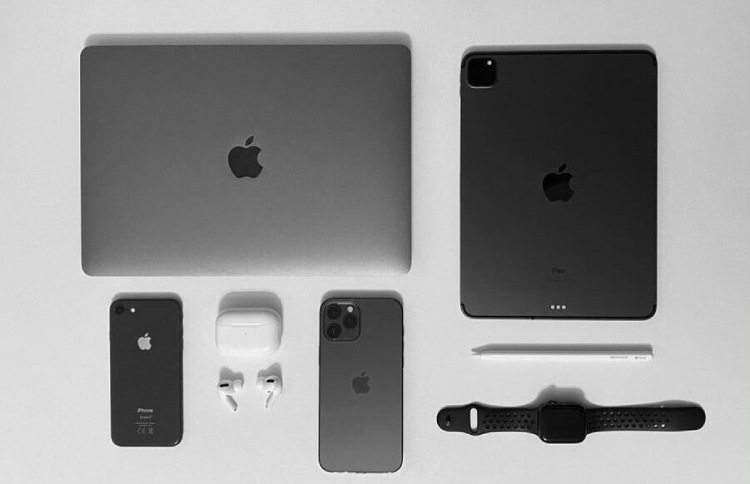 An image of several Apple products lined up on a table 